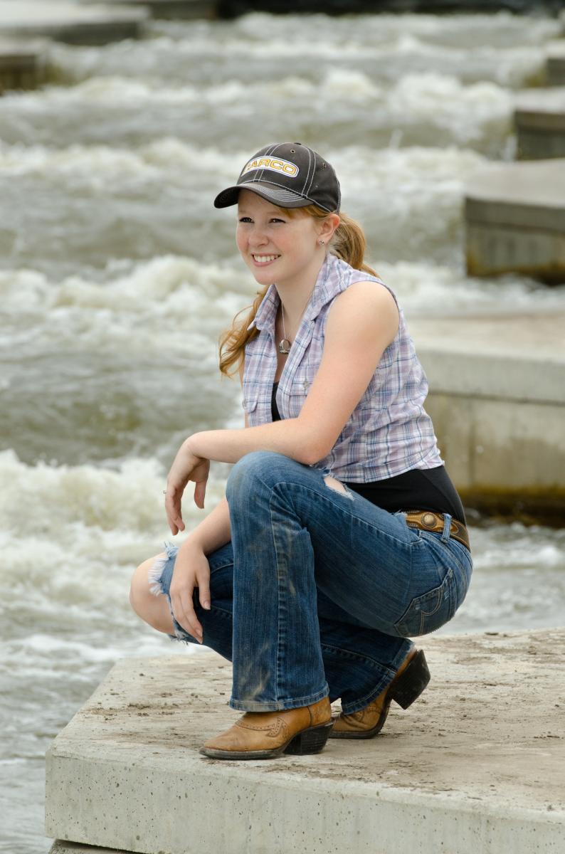 Raging water offers a intense backdrop for senior pictures by Robertsons' Warehouse Photography, Wichita, KS