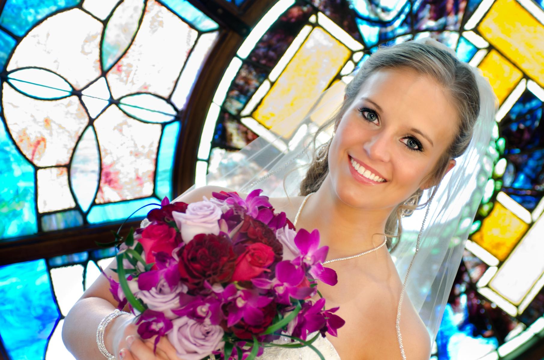 In this eye-catching bridal portrait, her blue eyes are intensified by all the shades of blue in the background, by Robertsons' Warehouse Photography, Wichita, KS