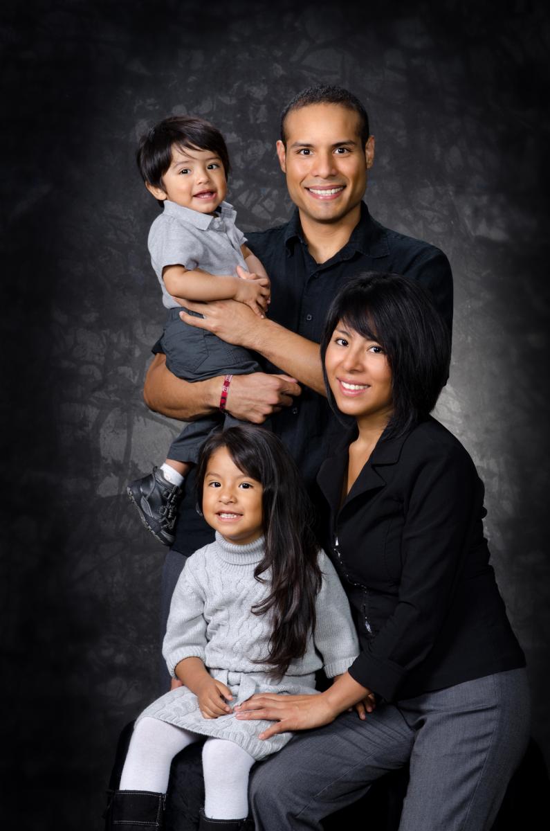 Contemporary background and posing gives another interesting choice for the Jaimes family portrait, by Robertsons' Warehouse Photography, Wichita, KS